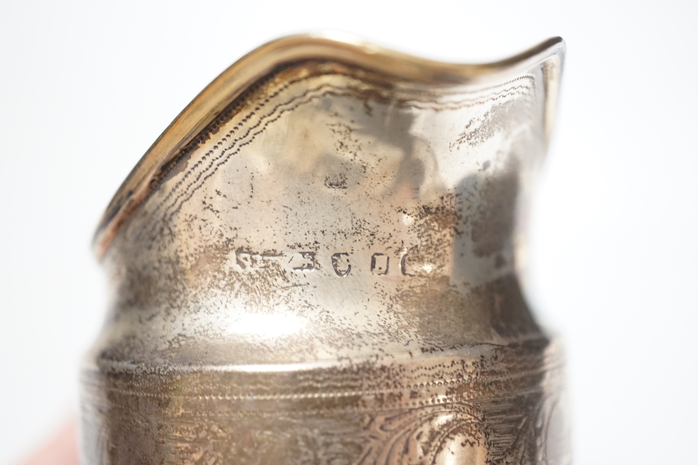 A George III silver cream jug, marks rubbed, 10.3cm.